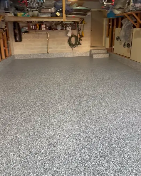 After: the same garage with a finished grey flake epoxy floor