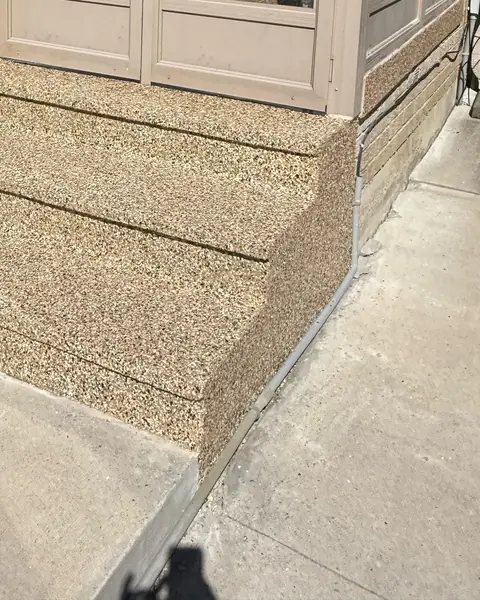 Front entry steps finished with a tan flake coating